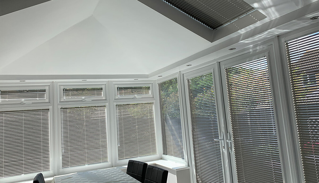Metal venetian blinds in a conservatory setting